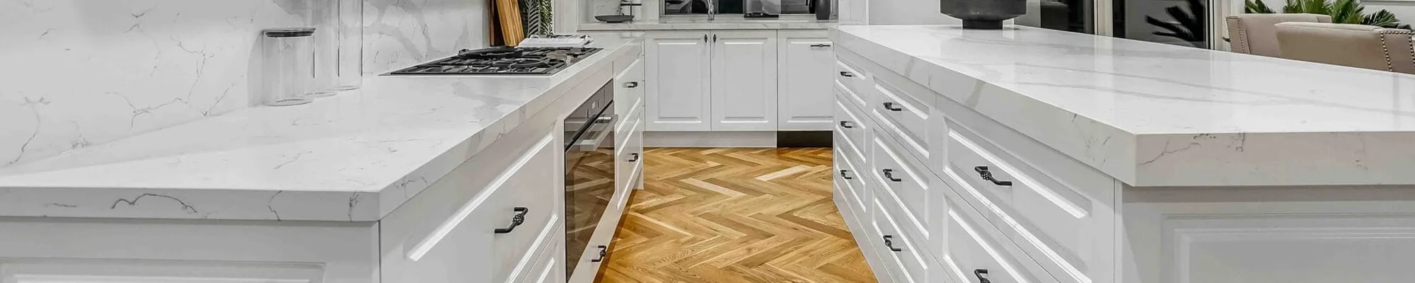 Beautiful hardwood flooring in modern white kitchen provided by Johnson & Sons Flooring in the Knoxville, TN area